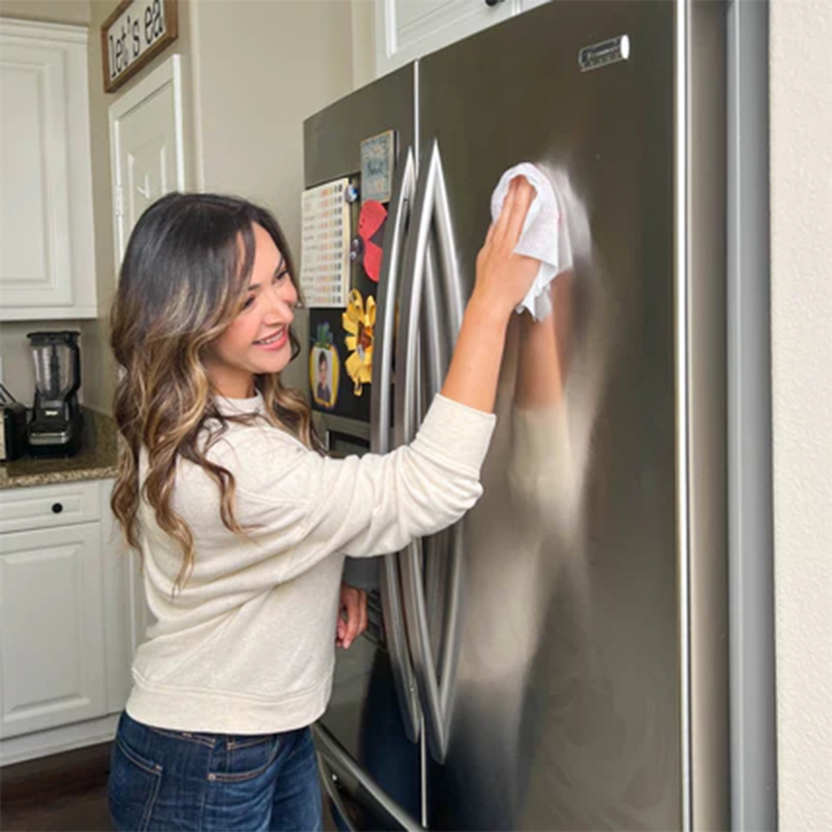 SONO Alcohol-Free Disinfecting Wipes in action, cleaning a stainless steel refrigerator in a home kitchen, ensuring a streak-free shine.